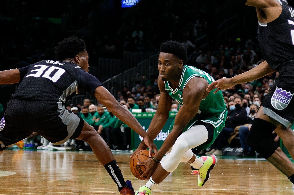 Sacramento Kings center Damian Jones (30) gets a hand on the ball as Boston Celtics forward Aaron Nesmith (26) tries to drive past him during the second half at TD Garden. Winslow Townson, USA TODAY Sports/Reuters