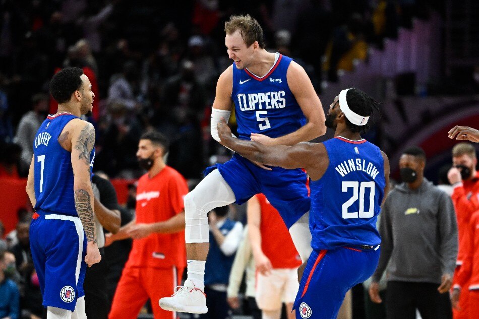 LA Clippers guard Luke Kennard (5) reacts after making a three-point basket while being fouled late in the fourth quarter against the Washington Wizards at Capital One Arena. Kennard would make the free-throw to take a one point lead with 1.9 seconds left in the game. Brad Mills, USA TODAY Sports/Reuters