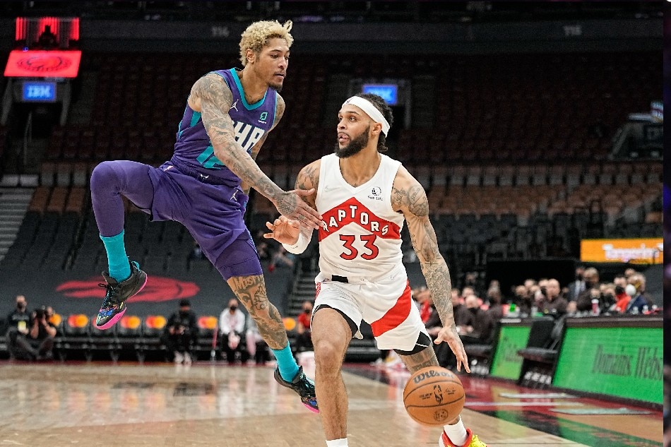 Toronto Raptors guard Gary Trent Jr. (33) dribbles the ball around Charlotte Hornets guard Kelly Oubre Jr. (12) during the second half at Scotiabank Arena. John E. Sokolowski, USA TODAY Sports/Reuters