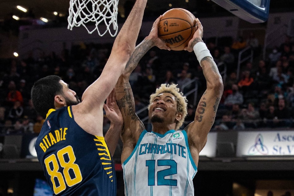 Charlotte Hornets guard Kelly Oubre Jr. (12) shoots the ball while Indiana Pacers center Goga Bitadze (88) defends in the first half at Gainbridge Fieldhouse. Trevor Ruszkowski, USA TODAY Sports/Reuters