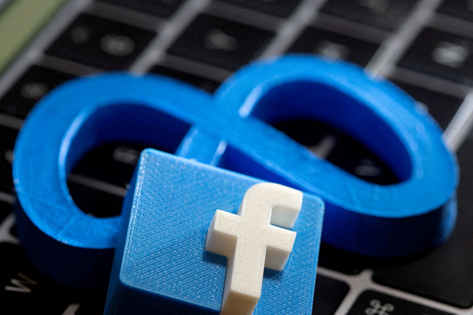 A 3D-printed Facebook's new rebrand logo Meta and Facebook logo are placed on laptop keyboard in this illustration taken on November 2, 2021. Dado Ruvic, Reuters/Illustration/File Photo
