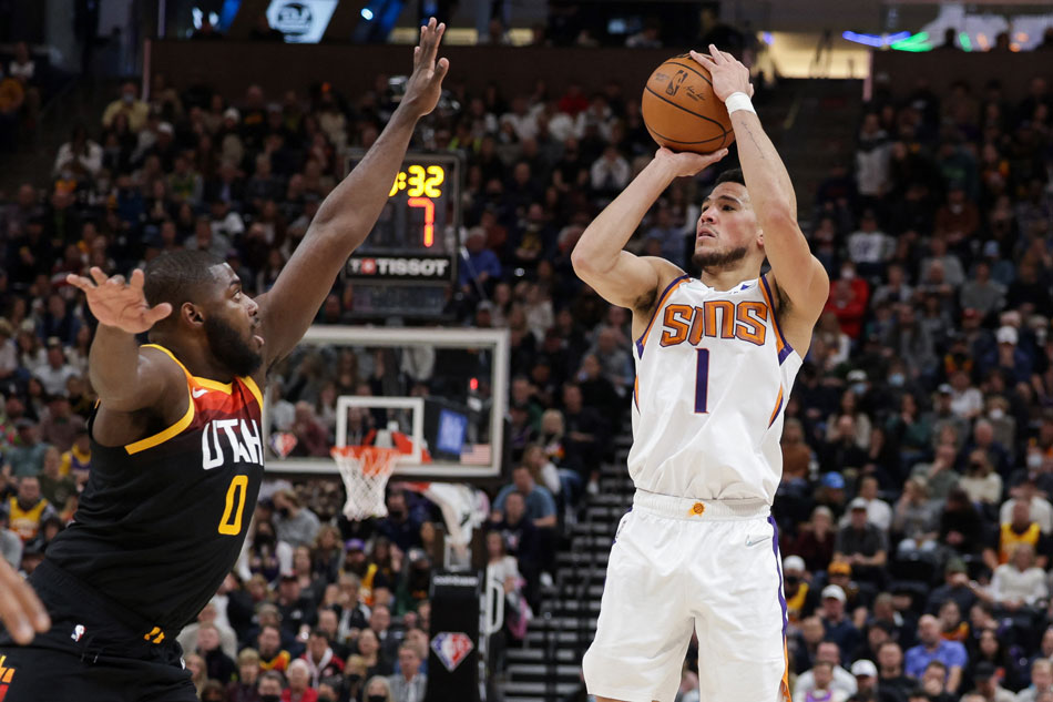 Phoenix Suns guard Devin Booker (1) shoots the ball over Utah Jazz forward Eric Paschall (0) during the third quarter at Vivint Arena. Chris Nicoll, USA TODAY Sports/Reuters,
