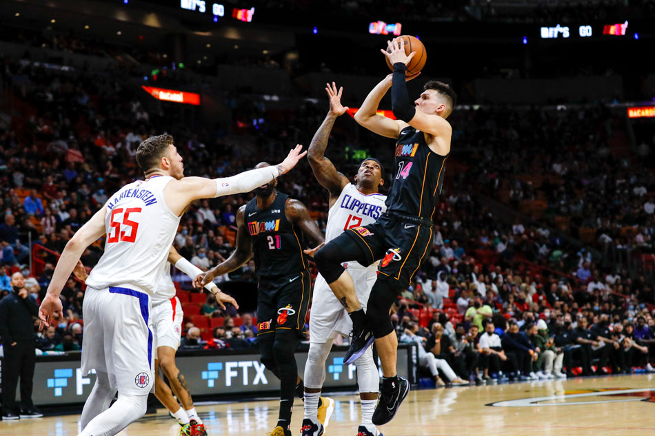 Heat guard Tyler Herro shoots over Clippers teammates Isaiah Hartenstein and Eric Bledsoe in their game on January 28, 2022. Sam Navarro, USA Today Sports/Reuters
