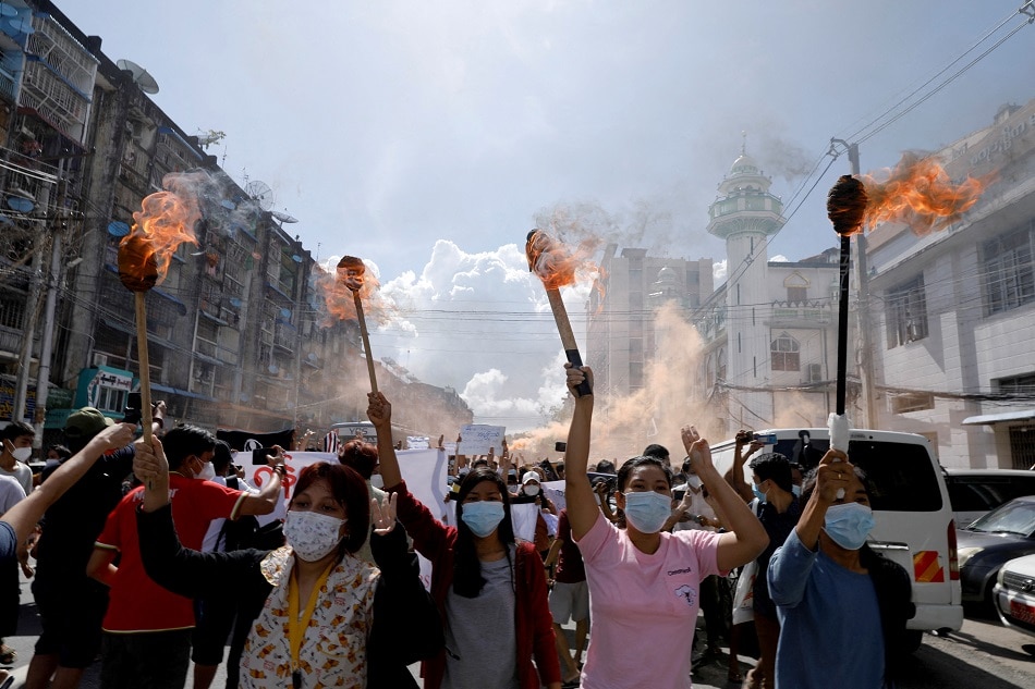 A group of women hold torches as they protest against the military coup in Yangon, Myanmar July 14, 2021. REUTERS/Stringer/File