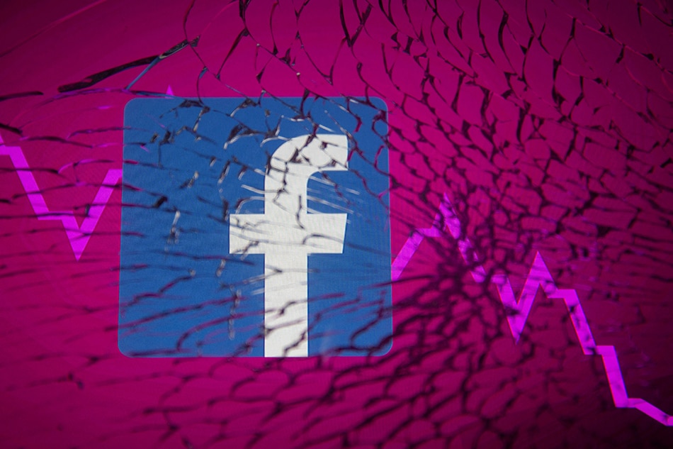 Facebook logo and stock graph are displayed through broken glass in this illustration taken October 4, 2021. Dado Ruvic/Reuters Illustration/File Photo