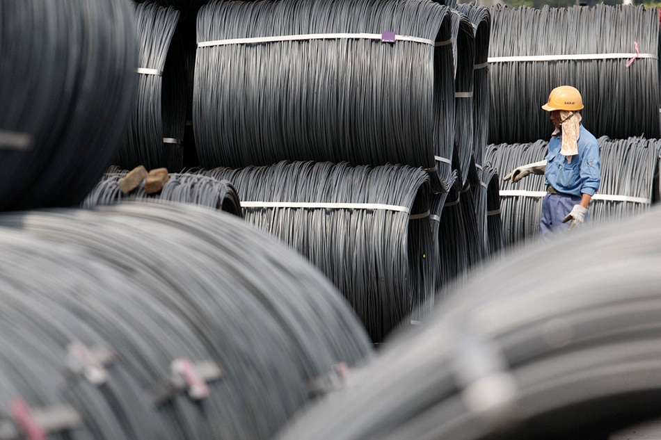 A worker checks steel coils at a steel collection facility in Tokyo August 19, 2009. Japan's crude steel output dropped 24.9 percent in July from a year earlier to 7.66 tonnes, falling for the tenth straight month, the Japan Iron and Steel Federation said on Wednesday. Issei Kato, Reuters/File Photo