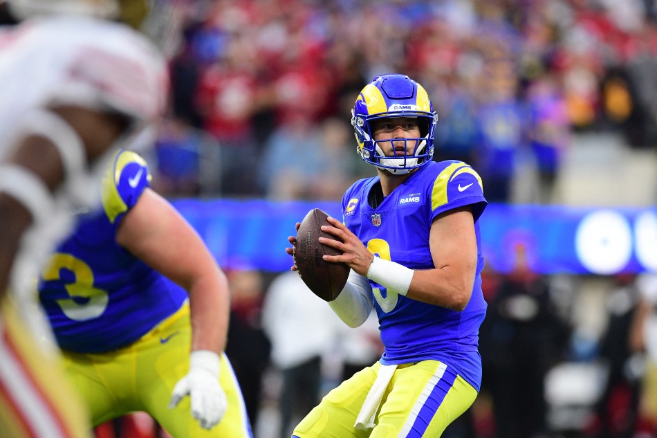 Los Angeles Rams quarterback Matthew Stafford (9) looks to pass while being  chased by San Franc …