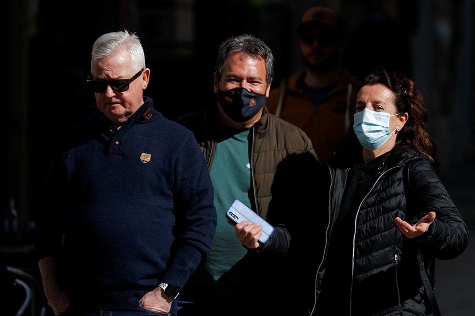 A man walks without face mask on a street, as Spain lifts the rule for people to wear masks outdoors, amid the coronavirus disease (COVID-19) pandemic in Ronda, Spain, February 10, 2022. Jon Nazca, Reuters