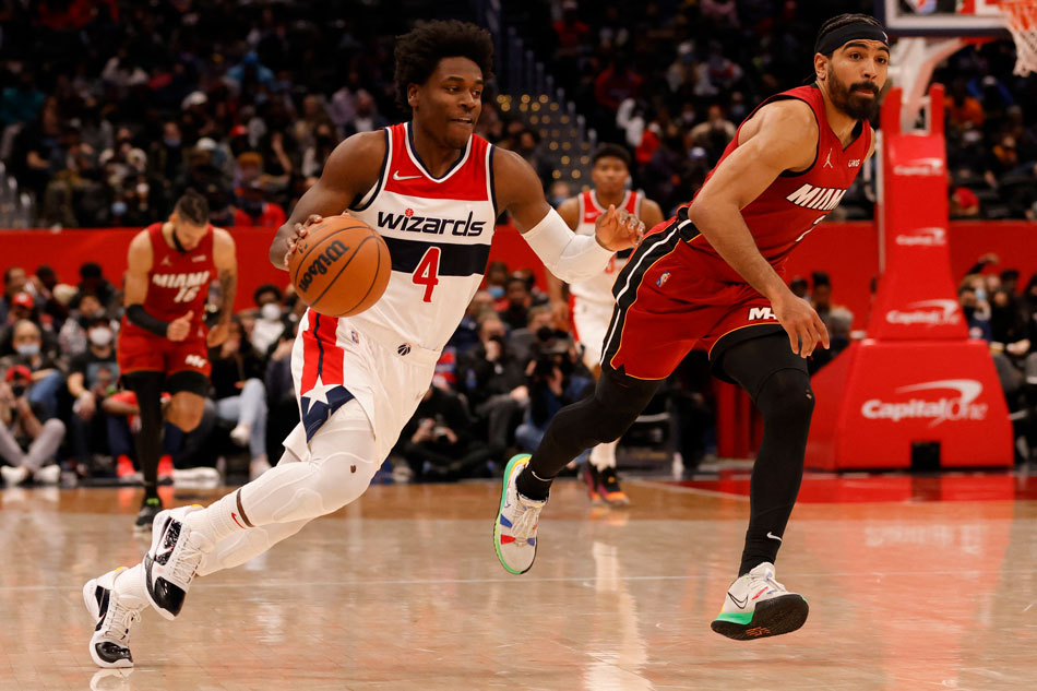 Washington Wizards guard Aaron Holiday (4) drives to the basket as Miami Heat guard Gabe Vincent (2) chases during the first quarter at Capital One Arena. Geoff Burke, USA TODAY Sports via Reuters