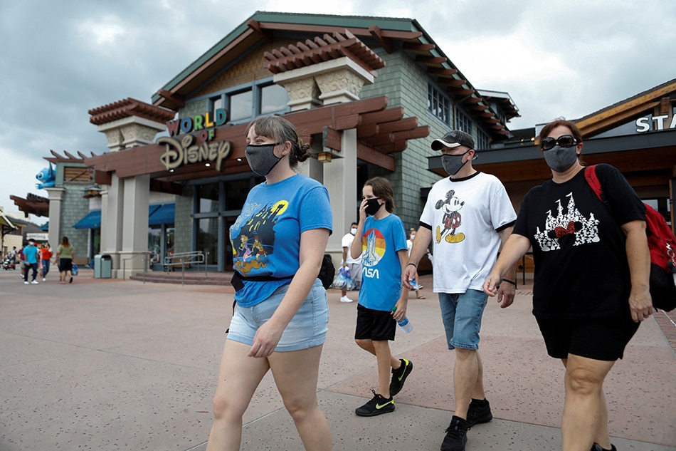 Summer Selmon, her brother Levi, and their parents Dave and Brandi wear face masks while visiting the Disney Springs shopping and dining district during their vacation at Walt Disney World during a phased reopening from coronavirus disease (COVID-19) restrictions in Lake Buena Vista, Florida. Octavio Jones, Reuters File Photo