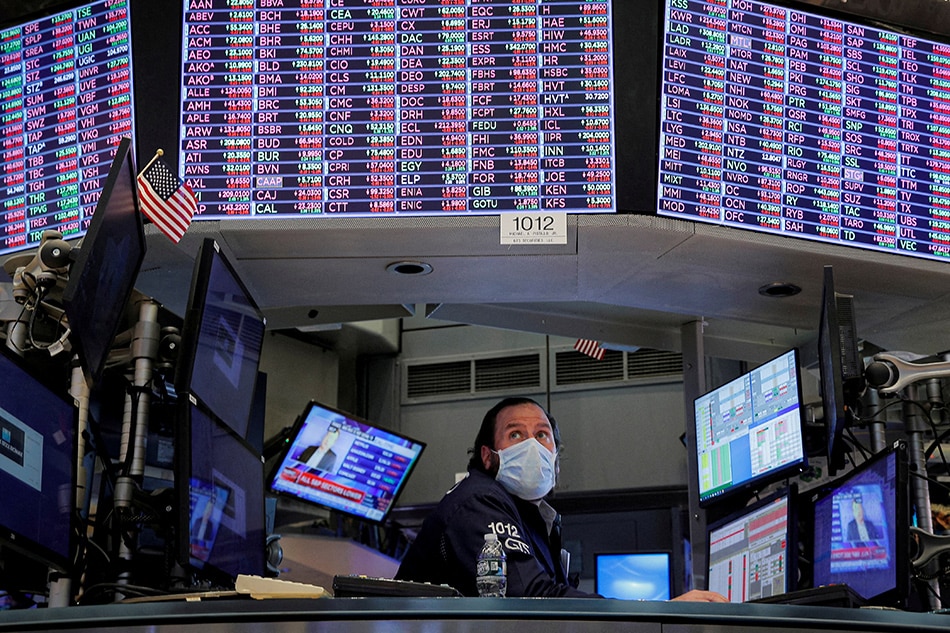 A specialist trader works inside a booth on the floor of the New York Stock Exchange (NYSE) in New York City, U.S., January 18, 2022. Brendan McDermid, Reuters/File Photo