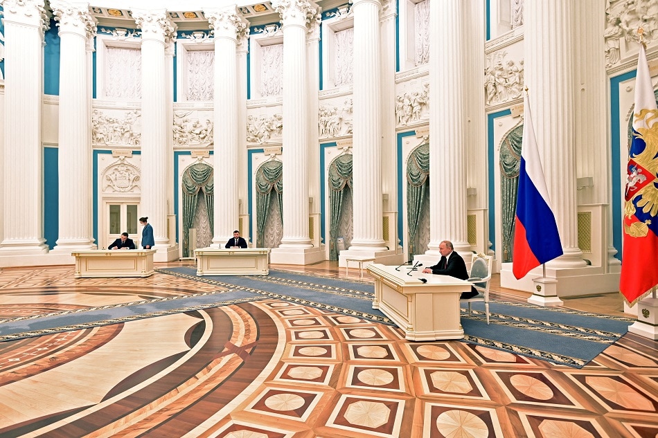 Russian President Vladimir Putin attends a ceremony to sign documents, including a decree recognizing 2 Russian-backed breakaway regions in eastern Ukraine as independent entities, with leaders of the self-proclaimed republics Leonid Pasechnik and Denis Pushilin seen in the background, in Moscow, in this picture released February 21, 2022. Alexey Nikolsky, Sputnik/Kremlin via Reuters