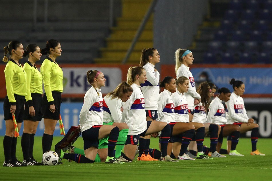 United States' players, most kneeling against racism, listen to their national anthem ahead of the women's friendly football match between the Netherlands and the United States of America (USA), at the Rat Verlegh Stadium in Breda, the Netherlands, on November 27, 2020. File photo. Dean Mouhtaropoulos, AFP.