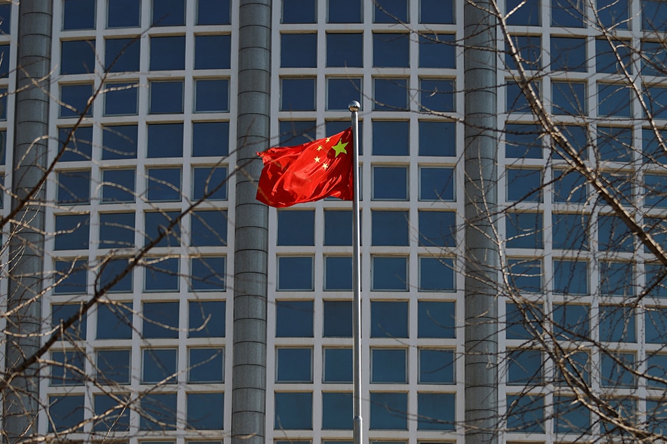 A Chinese flag flutters outside the Chinese foreign ministry in Beijing, China February 24, 2022. Carlos Garcia Rawlins, Reuters