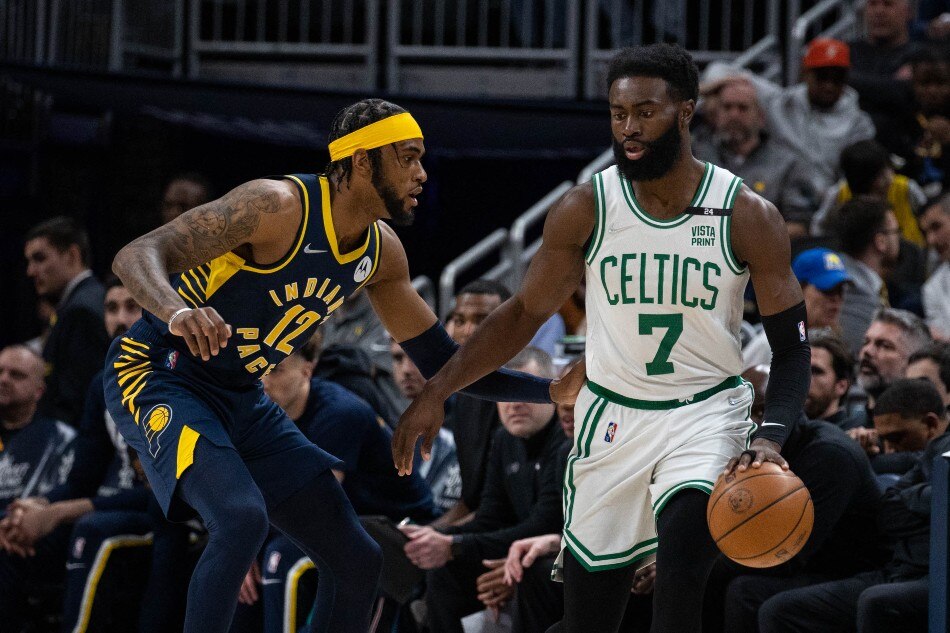 Boston Celtics guard Jaylen Brown (7) dribbles the ball while Indiana Pacers forward Oshae Brissett (12) defends in the first half at Gainbridge Fieldhouse. Trevor Ruszkowski, USA TODAY Sports/Reuters. 
