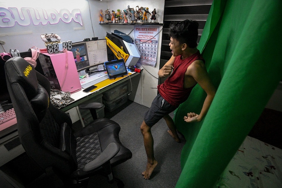 Jhanzen Latorre, a.k.a. Bulldog, performs a dance routine as he streams a game from his home in Las Piñas City. Mark Demayo, ABS-CBN News