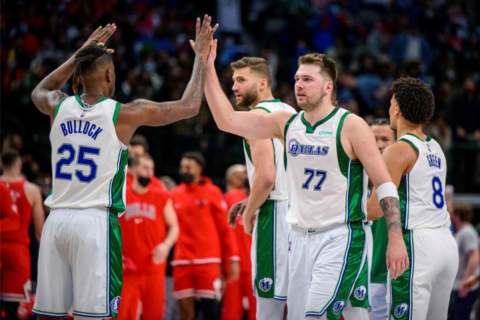 Dallas teammates Luka Doncic and Reggie Bullock celebrate during their game against Chicago on January 9, 2022. Jerome Miron, USA Today Sports/Reuters