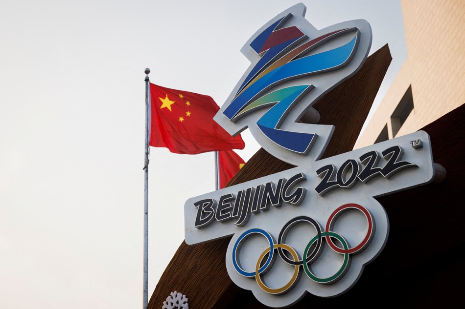 The Chinese national flag flies behind the logo of the 2022 Winter Olympics in Beijing, on January 14, 2022. Thomas Peter, Reuters/file