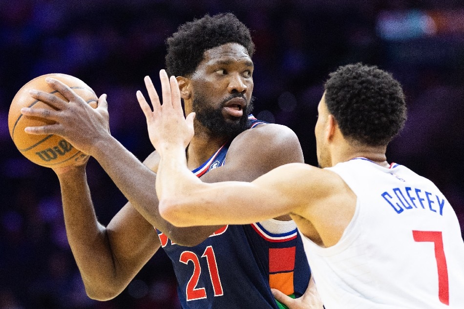 76ers center Joel Embiid controls the ball against LA Clippers guard Amir Coffey in their game January 21, 2022. Bill Streicher, USA Today Sports/Reuters