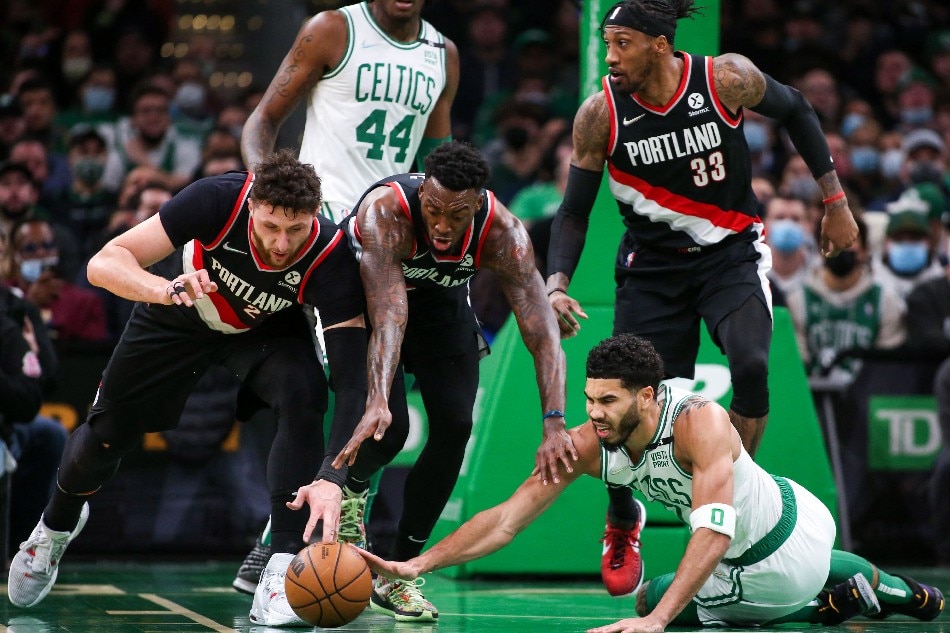 Celtics forward Jayson Tatum dives for a loose ball against Blazers center Jusuf Nurkic and forward Nassir Little in their game January 21, 2022. Paul Rutherford, USA Today Sports/Reuters