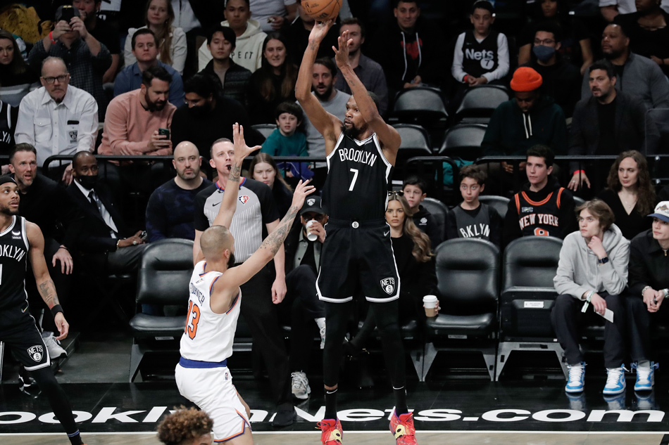  Brooklyn Nets forward Kevin Durant shoots (C) shoots over New York Knicks guard Evan Fournier during the first half of the NBA basketball game between the Brooklyn Nets and the New York Knicks at Barclays Center in Brooklyn, New York, USA, 13 March 2022. Peter Foley, EPA-EFE.
