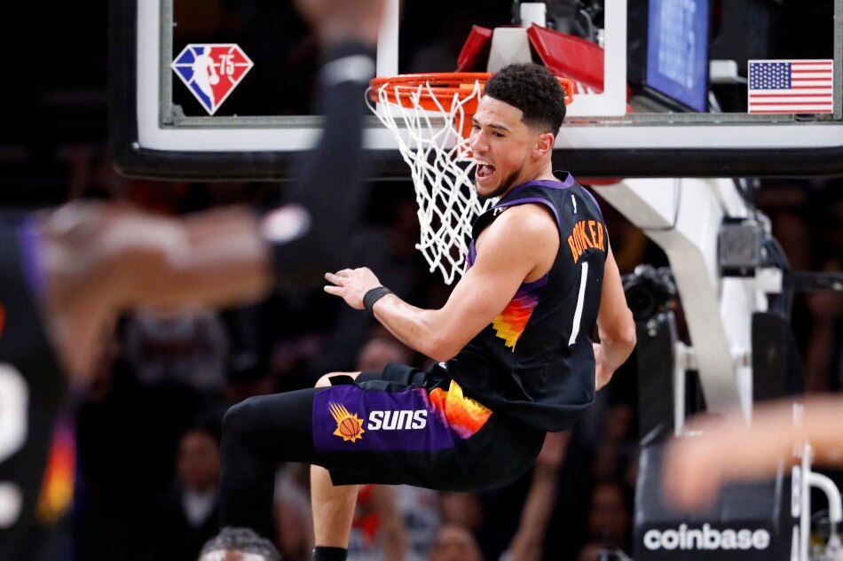 Devin Booker #1 of the Phoenix Suns reacts after dunking the ball during the first half against the Los Angeles Lakers at Footprint Center on March 13, 2022 in Phoenix, Arizona. File photo. Chris Coduto, Getty Images/AFP