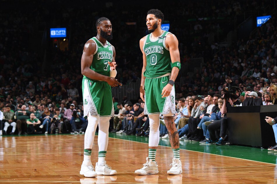 Jaylen Brown #7 and Jayson Tatum #0 of the Boston Celtics talk during the game against the Brooklyn Nets on March 6, 2022 at the TD Garden in Boston, Massachusetts. File photo. Brian Babineau, NBAE via Getty Images/AFP.