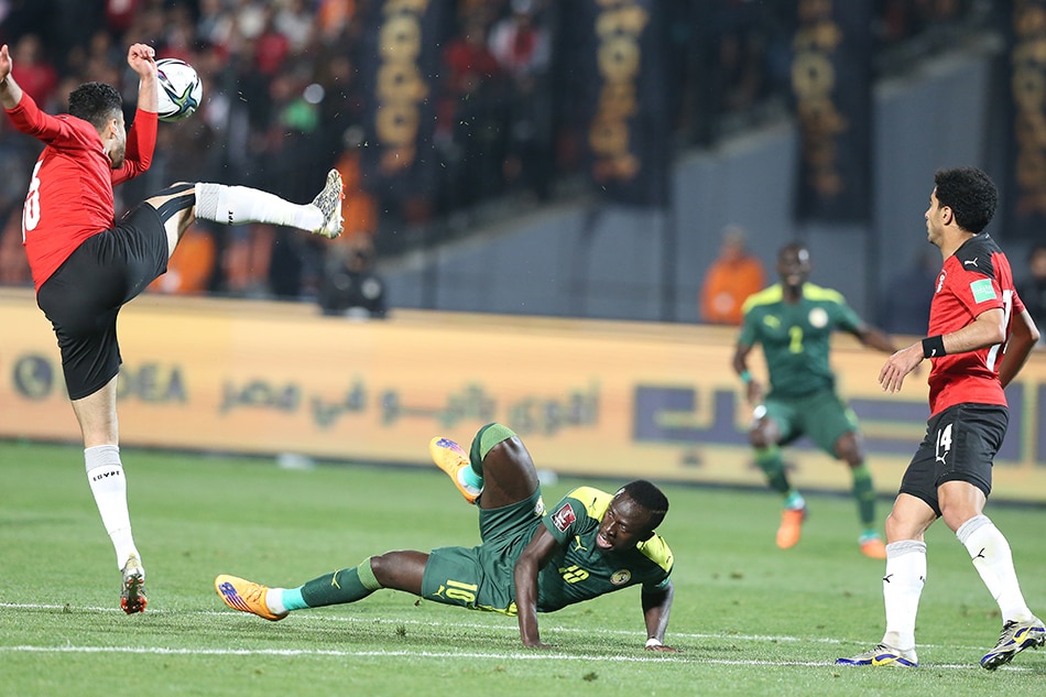 Ahmed Fatoh (L) and Omar Gaber (R) of Egypt vies for the ball with Sadio Mane of Senegal during the FIFA Qatar 2022 World Cup Africa qualifiers match between Egypt and Senegal at the International Cairo stadium in Cairo, Egypt, 25 March 2022. Khaled Elfiqi, EPA-EFE