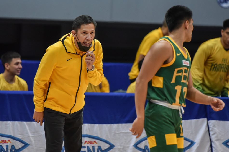 FEU coach Olsen Racela gives instructions to guard LJay Gonzales during their UAAP Season 84 first round game against the UP Fighting Maroons. UAAP Media.