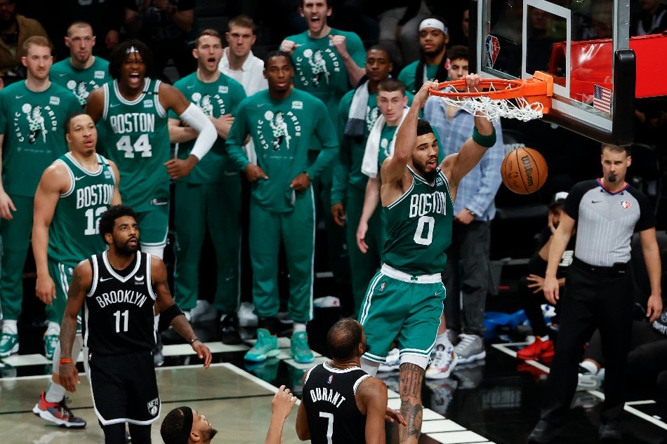 Boston Celtics forward Jayson Tatum (top) dunks the ball past Brooklyn Nets forward Kevin Durant (C-R), Kyrie Irving (L) and Bruce Brown (C) in the second half of their NBA Eastern Conference first round playoff Game 3 at the Barclays Center in Brooklyn, New York, USA, 23 April 2022. Jason Szenes, EPA-EFE
