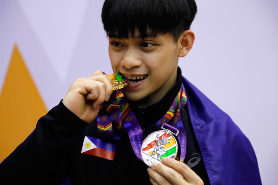 Carlos Edriel Yulo poses with his medals on the podium after winning the individual all-around competition and taking the second place in the team competition in artistic gymnastics at the 31st SEA Games in Hanoi, Vietnam, May 13, 2022. Luong Thai Linh, EPA-EFE