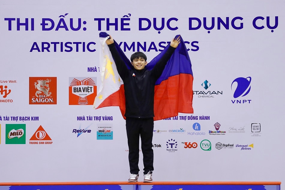 Carlos Edriel Yulo Poquiz of the Philippines celebrates on the podium after winning the individual all-around competition and taking the second place in the team competition of the Artistic Gymnastics events at the 31st Southeast Asian Games (SEA Games 31) in Hanoi, Vietnam, 13 May 2022. EPA-EFE/LUONG THAI LINH
