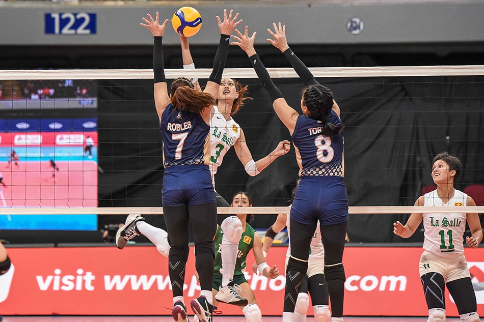 De La Salle middle blocker Thea Gagate attacks against the double-block of National University in their UAAP Season 84 first round match. UAAP Media.