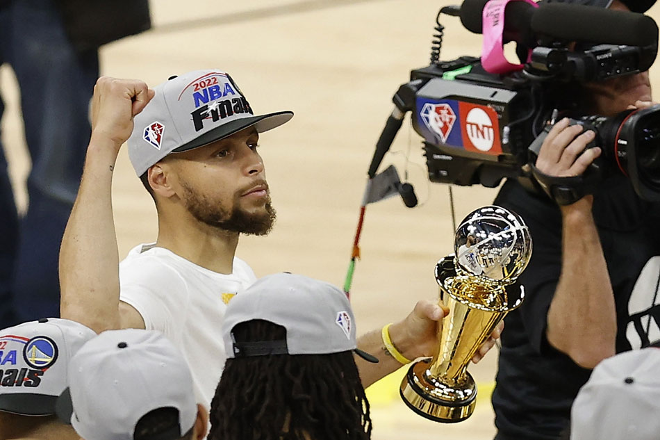 Golden State Warriors guard Stephen Curry holds the MVP trophy at the conclusion of Game 5 of the NBA Western Conference Finals between the Golden State Warriors and the Dallas Mavericks, at Chase Center, in San Francisco, California, USA, 26 May 2022. John Mabanglo, EPA-EFE.