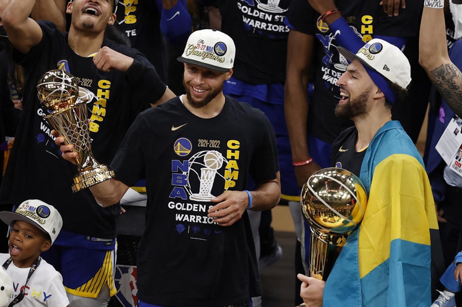 Warriors guard Stephen Curry holds the NBA Finals MVP Trophy, as guard teammate Klay Thompson holds the Larry O'Brien Trophy, following their Game 6 win June 16, 2022. John G Mabanglo, Shutterstock Out/EPA-EFE