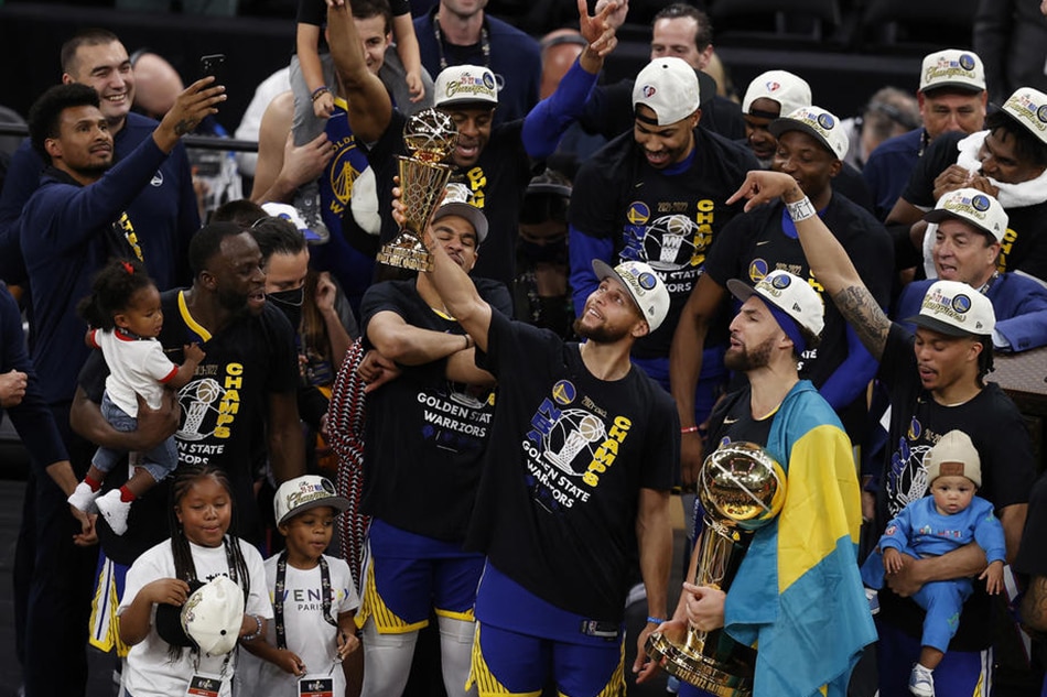 Warriors guard Stephen Curry holds the NBA Finals MVP Trophy, as teammate-guard Klay Thompson holds the Larry O'Brien Trophy, following their title-clinching Game 6 win on June 16, 2022. John G Mabanglo, Shutterstock Out/EPA-EFE