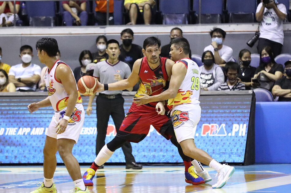 San Miguel center June Mar Fajardo looks to make a play against Rain or Shine's Norbert Torres in their PBA Philippine Cup game at the Araneta Coliseum. PBA Images.
