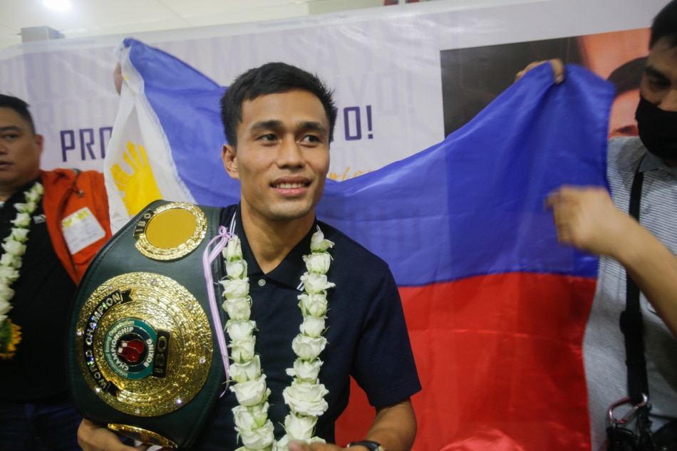 Dave “Doberman” Apolinario and his manager Michael Pelayo arrive at the Ninoy International Airport Terminal 1 on Wednesday, days after winning the IBO flyweight title. ABS-CBN News