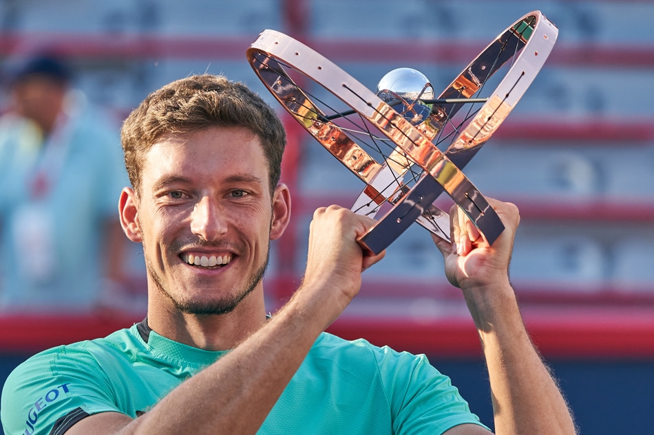Pablo Carreno Busta of Spain, poses with the trophy after his victory against Hubert Hurkacz of Poland, during the men's finals of the ATP National Bank Open tennis tournament, in Montreal, Canada, 14 August 2022. Andre Pichette, EPA-EFE.