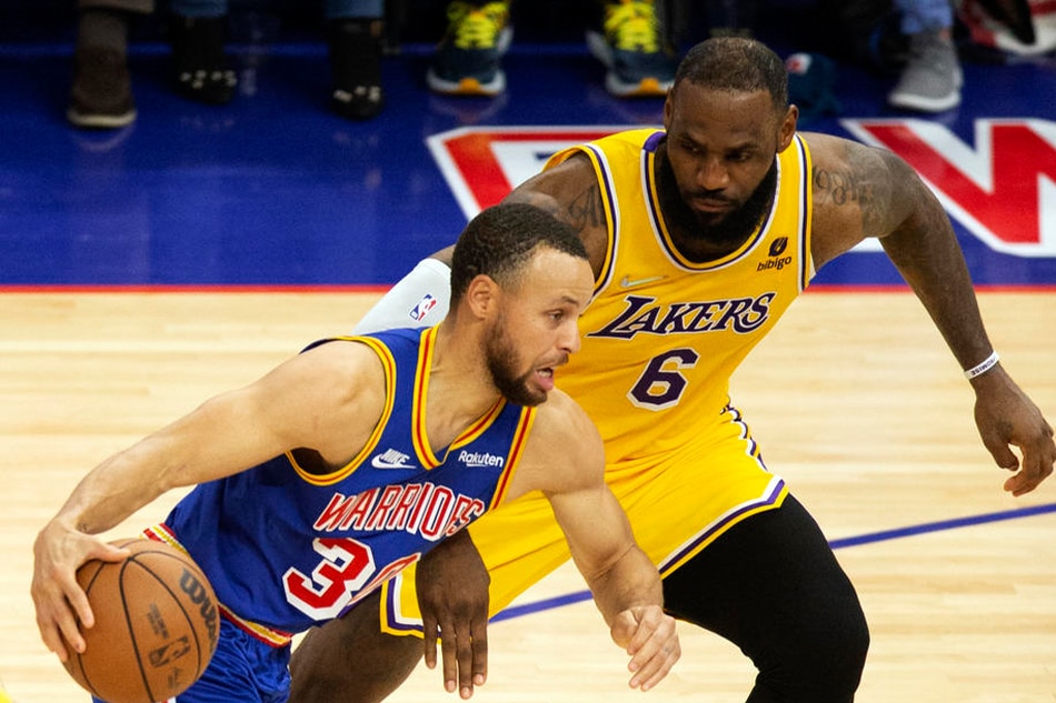 Warriors guard Steph Curry and Lakers forward LeBron James in action on February 12, 2022. D Ross Cameron, Shutterstock Out/EPA-EFE/file