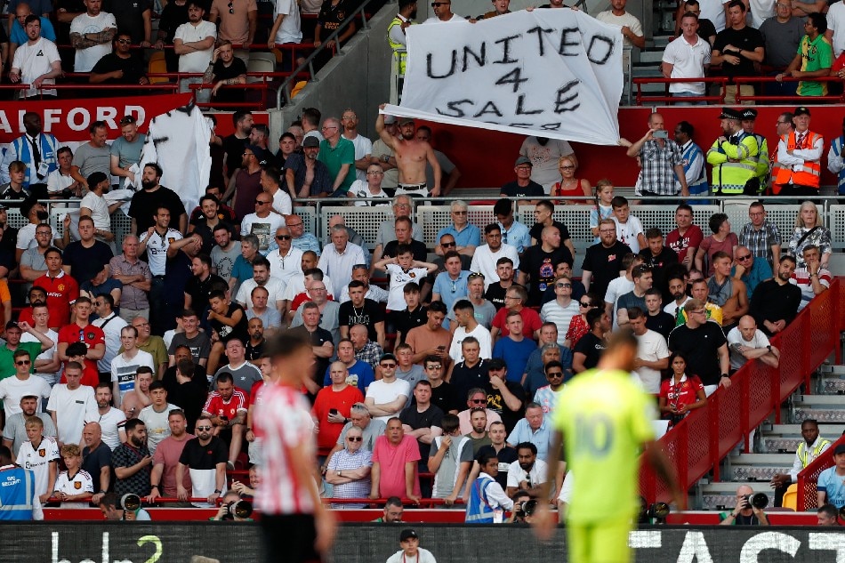 Manchester United fans hold up a banner against their owners during the English Premier League football match between Brentford and Manchester United at Gtech Community Stadium in London on August 13, 2022. Ian Kington, AFP