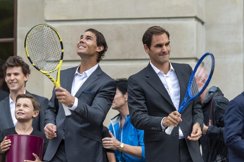 Rafael Nadal and Roger Federer throw balls to fans during the official welcome ceremony together with other tennis players ahead of the Laver Cup in Geneva, on September 18, 2019. Martial Trezzini, EPA-EFE/file
