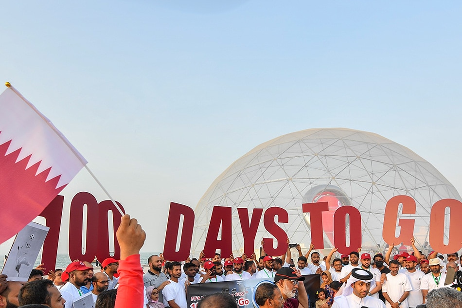 Soccer fans cheer during the ceremony of the Qatar 2022 FIFA World Cup countdown clock, marking 100 days to go till the beginning of the tournament in Doha, Qatar, 12 August 2022. Noushad Thekkayil, EPA-EFE.