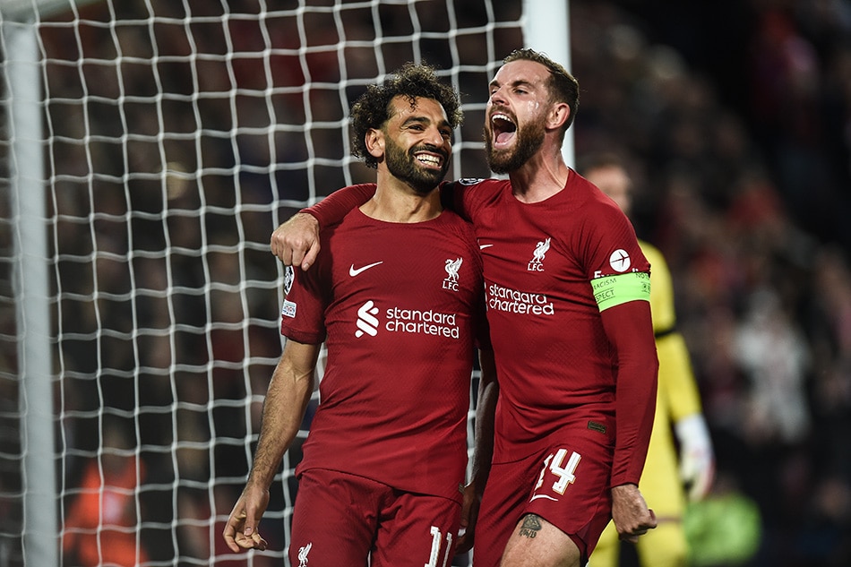 Mohamed Salah of Liverpool FC (L) celebrates with Jordan Henderson of Liverpool FC (R) after scoring a goal during the UEFA Champions League group A soccer match between Liverpool FC and Rangers FC in Liverpool, Britain, 04 October 2022. Peter Powell, EPA-EFE.