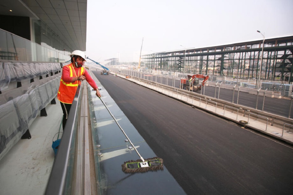 A cleaning lady works at the Hanoi Street Circuit in Vietnam on February 21, 2020. The race track was supposed to host the Vietnamese Formula One Grand Prix in April 2020. Luong Thai Linh, EPA-EFE/file