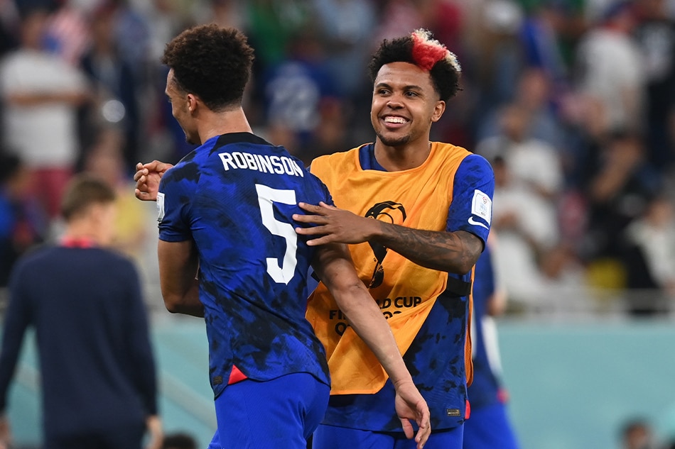 Weston Mckennie of the US (R) reacts with Antonee Robinson after the FIFA World Cup 2022 group B soccer match between Iran and the USA at Al Thumama Stadium in Doha, Qatar, 29 November 2022. EPA-EFE/Neil Hall