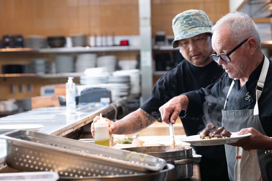 Roy Choi breaks bread with Chef Wolfgang Puck. Photo credit: Stephen Vanasco