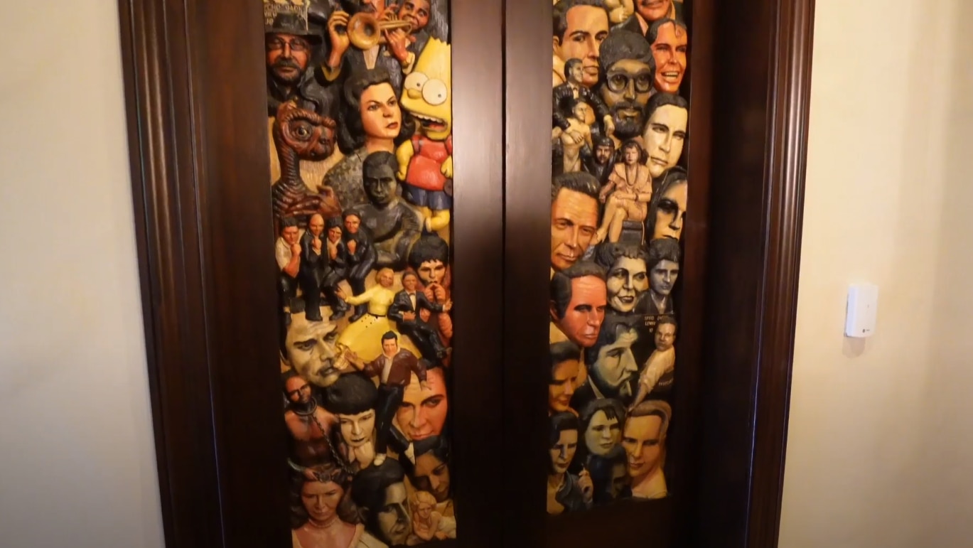 Carvings of celebrities on the door of the movie theatre in Entrelagos mansion