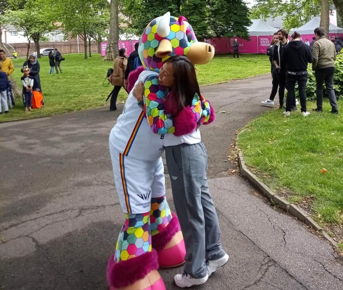 Baton bearer hugging the mascot