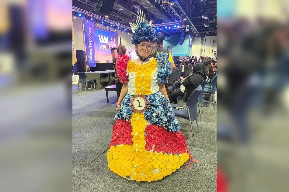 A young Filipina child sporting dress made of recycled col…